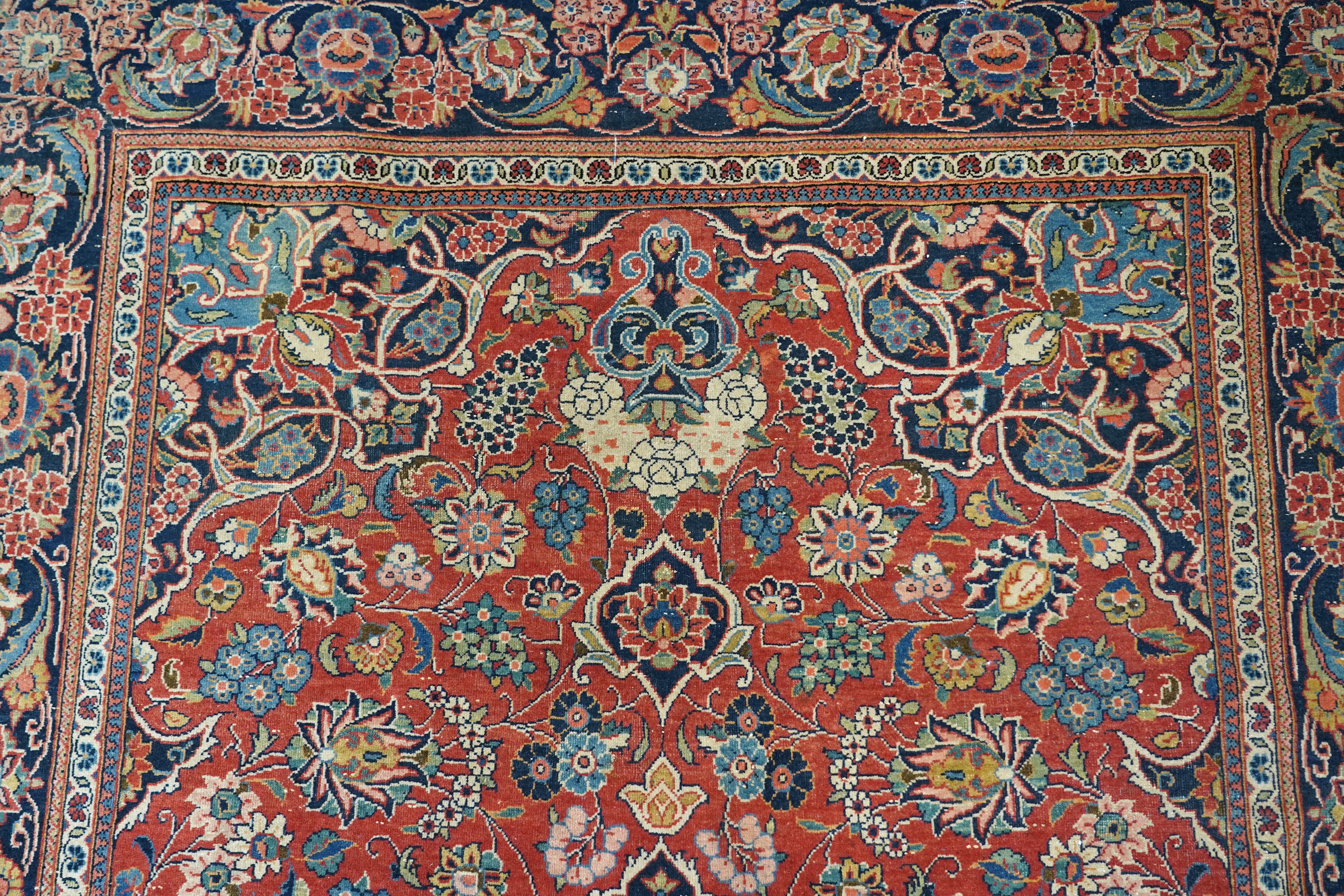 A pair of antique Tabriz brick red ground rugs, 200 x 136cm. Condition - fair